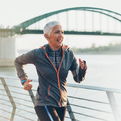 Pain Free Woman Running On Bridge